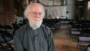 Archbishop Rowan Williams sitting in a chapel